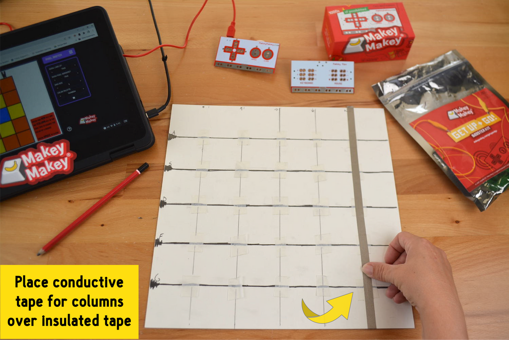 Place conductive tape for columns - drawing space surrounded by supplies and computer