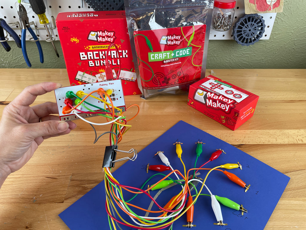 12 clips plugged into Makey Max and plugged onto the back of the paper clock.