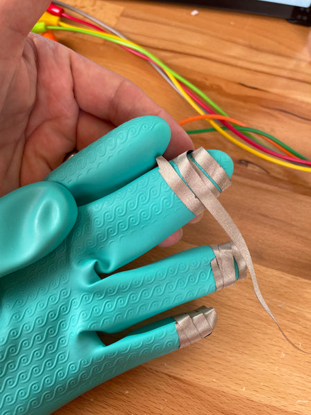 close up of conductive tape on fingers of gloves