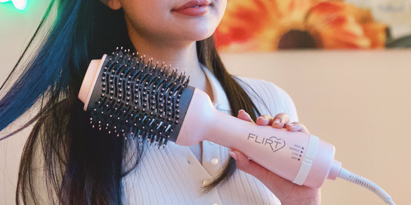 Girl holding a Tease Blowout Brush.