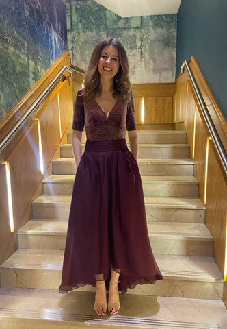 Carol standing in front of stairs smiling