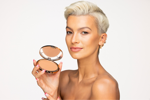 Model holding Sculpted Deluxe Bronzing Powder