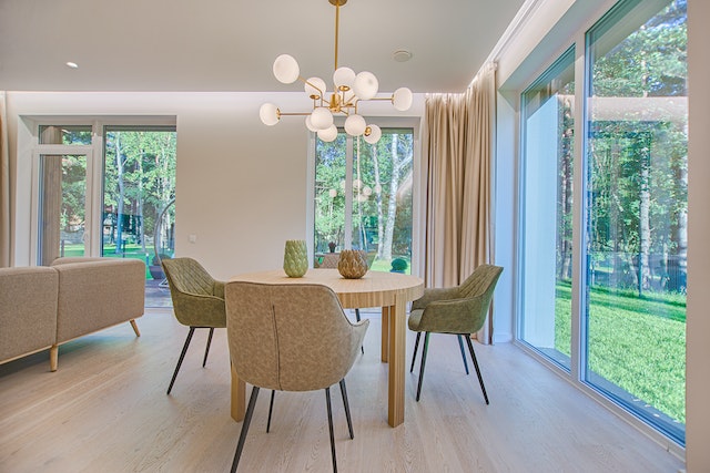 Knowing small houses' innate attractiveness is essential for successful staging. A round brown wooden piece dining set in a room.