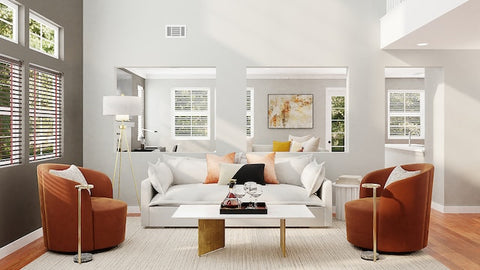 Embracing natural light is a cornerstone of minimalist staging for a stylish home, amplifying the beauty of simplicity. Couch and two chairs in a staged living room with large windows and two mirrors