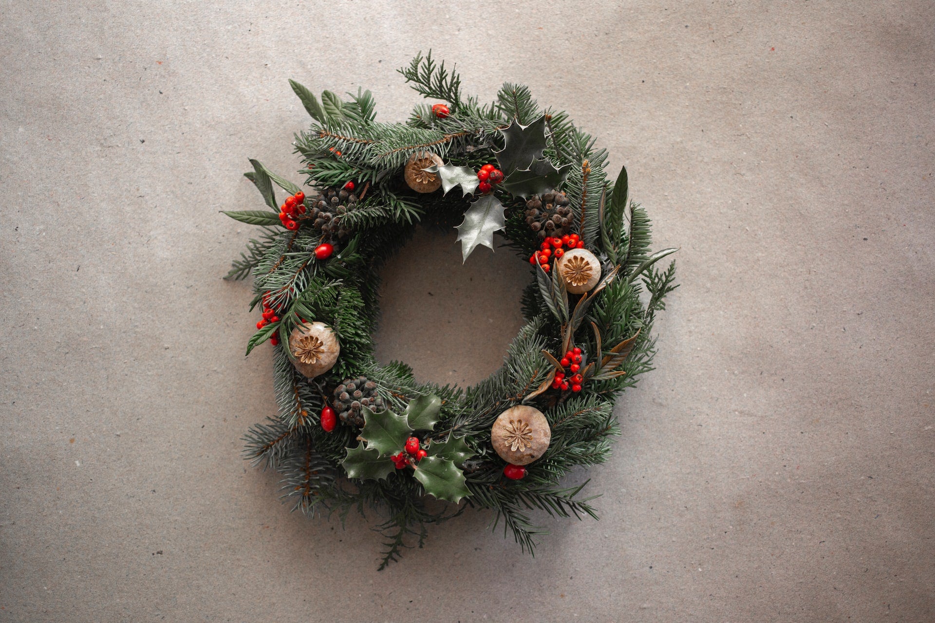 To improve curb appeal, decorate the porch with Christmas lights and the front door with an elegant wreath. An elegant Christmas wreath.