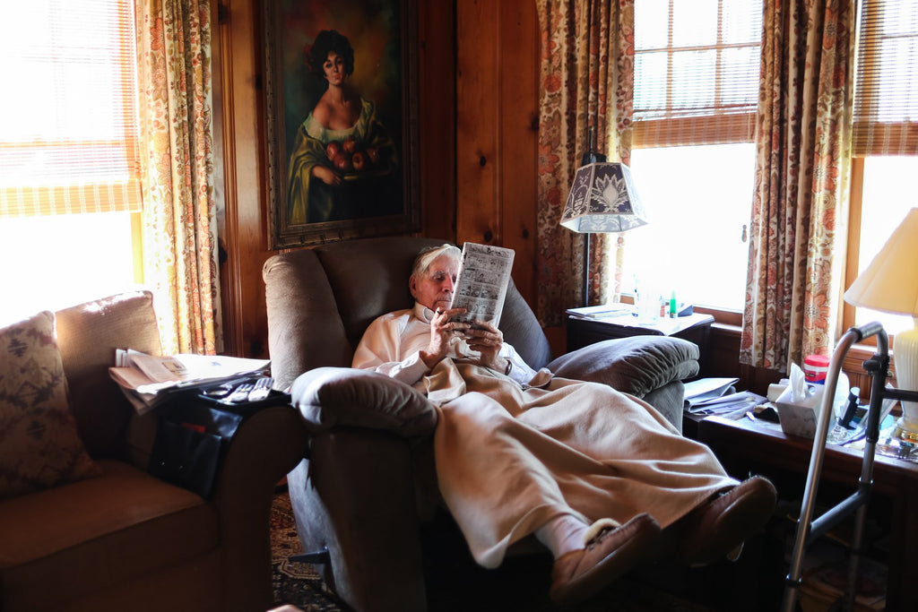 Elderly man reading while in a recliner | Quiet Time Photo Challenge