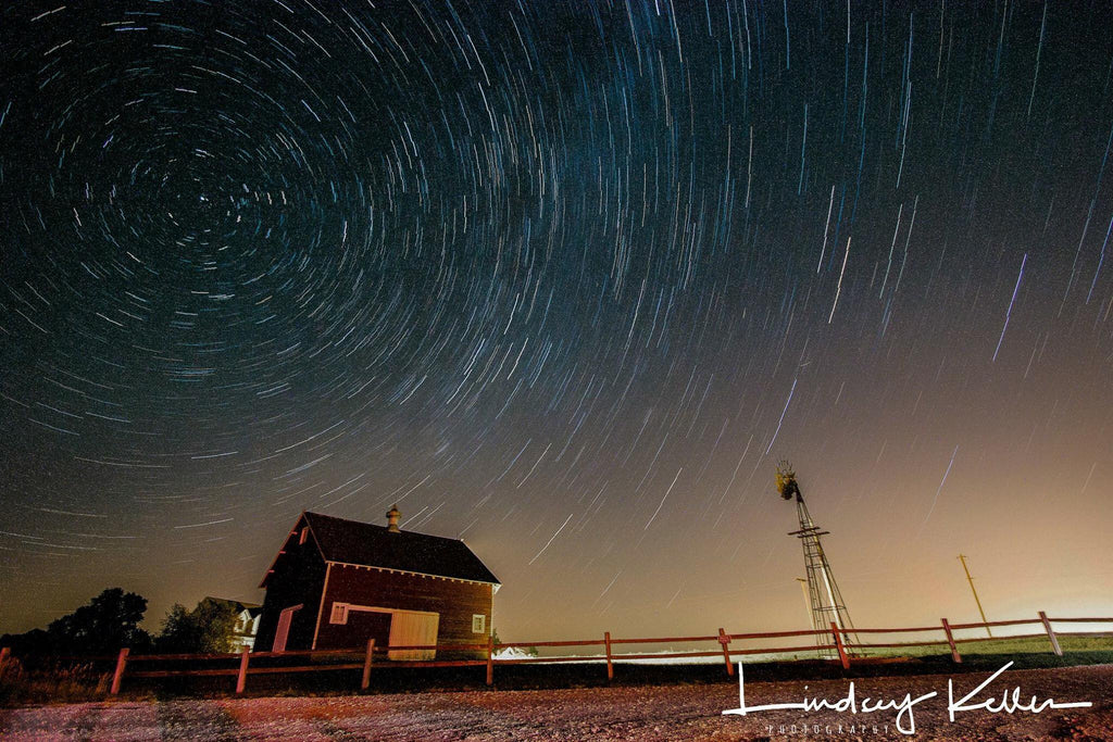 Night photo of starry sky over a farm house