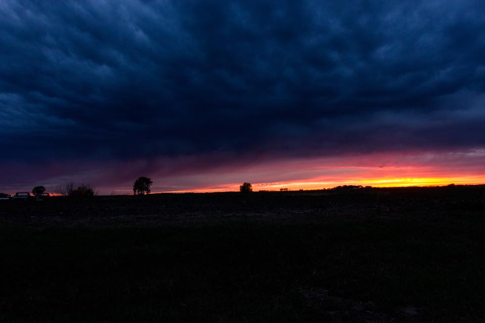 Night photo of thick clouds hanging over a field