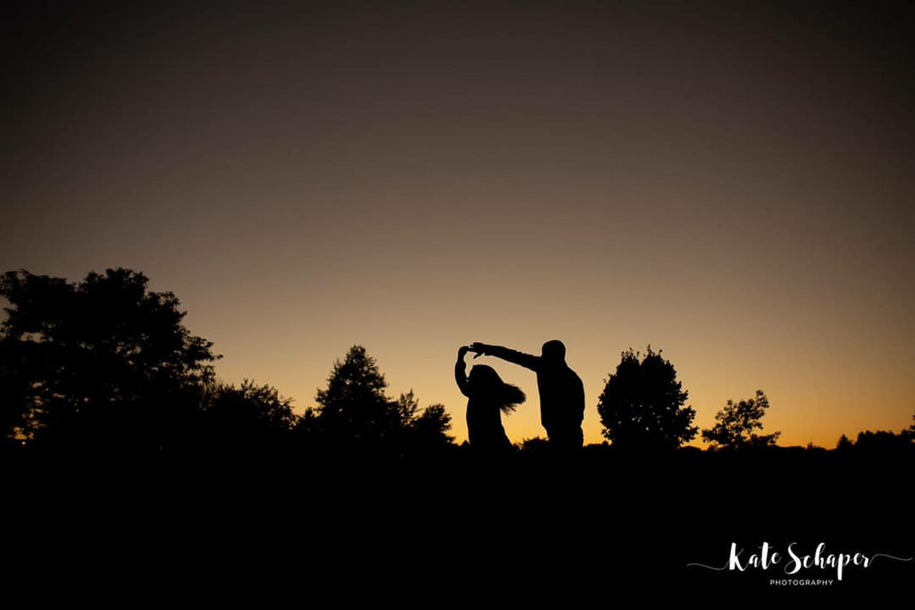silhouette photo of man twirling woman