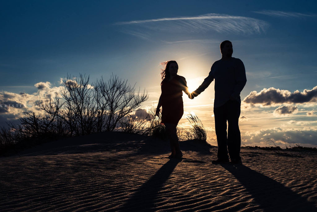 silhouette photograph of couple walking in the desert
