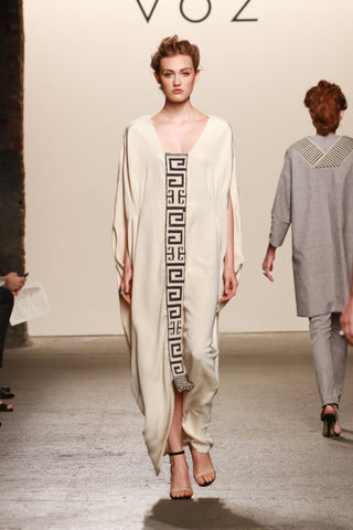 Model wearing a cream silk Camina Dress with geometric design