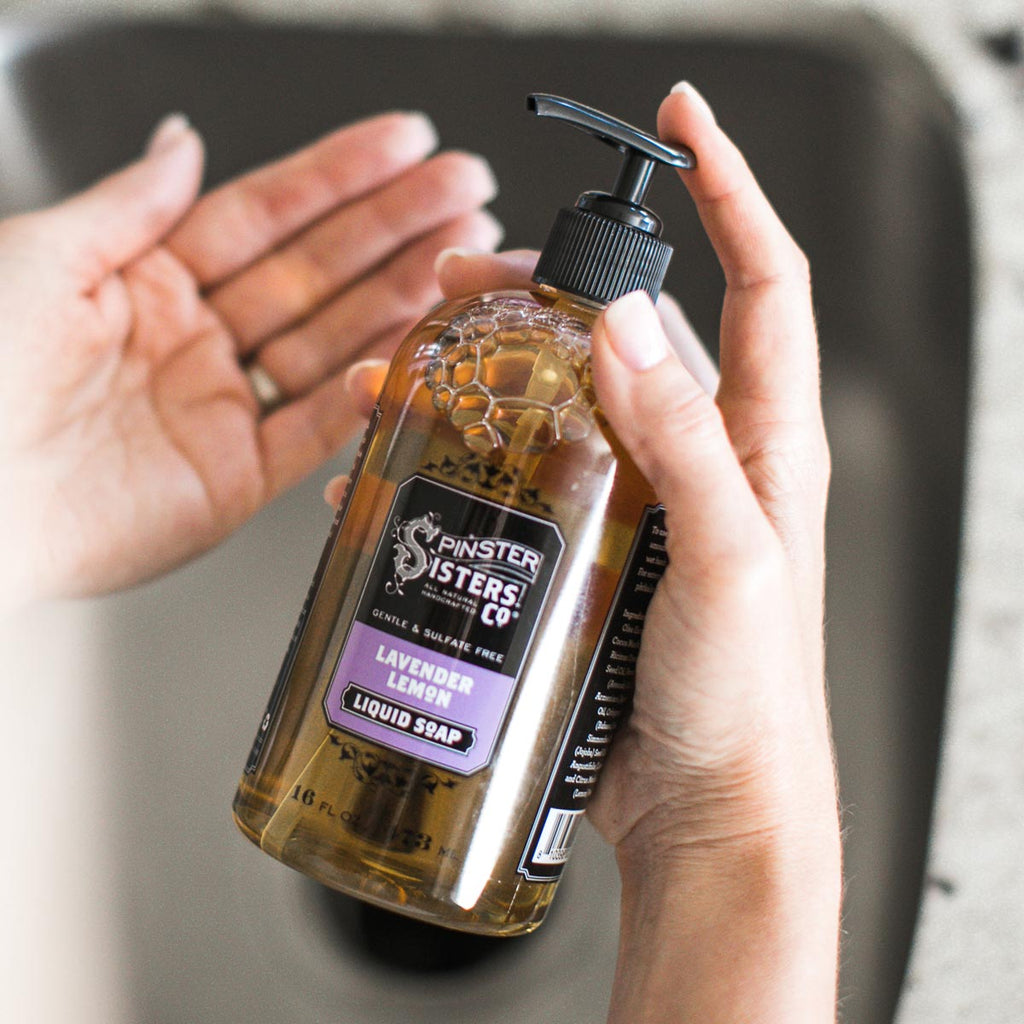 Hands Holding Lavender Lemon Liquid Soap over a sink