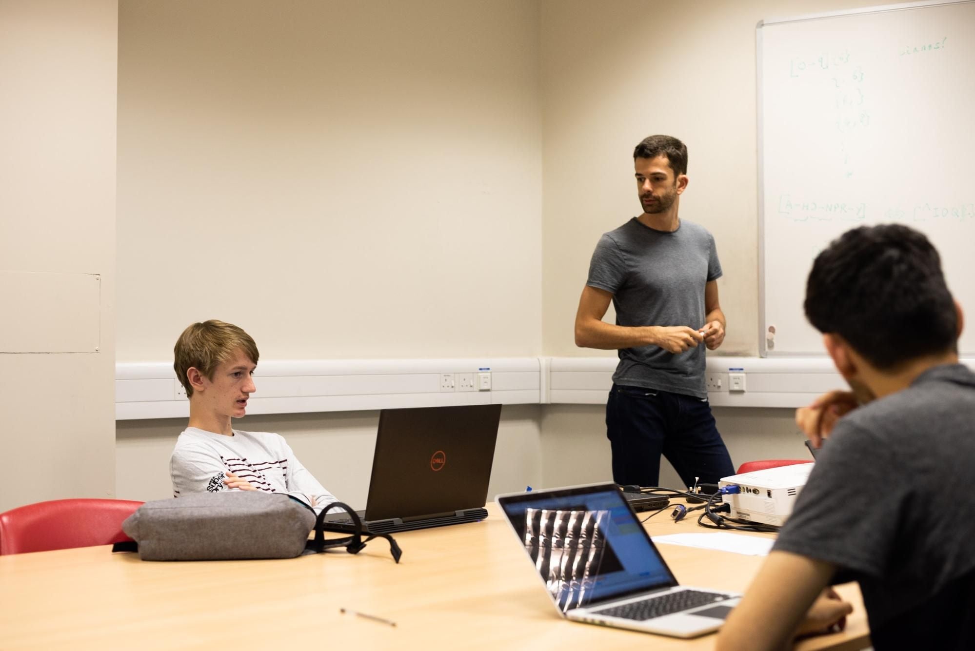 Tutor teaching coding in Oxford on our summer school