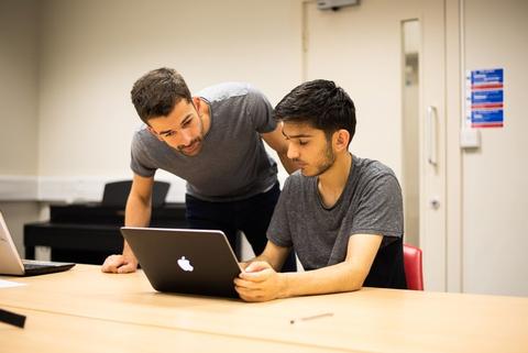 Tutor teaching coding student at our Oxford summer school