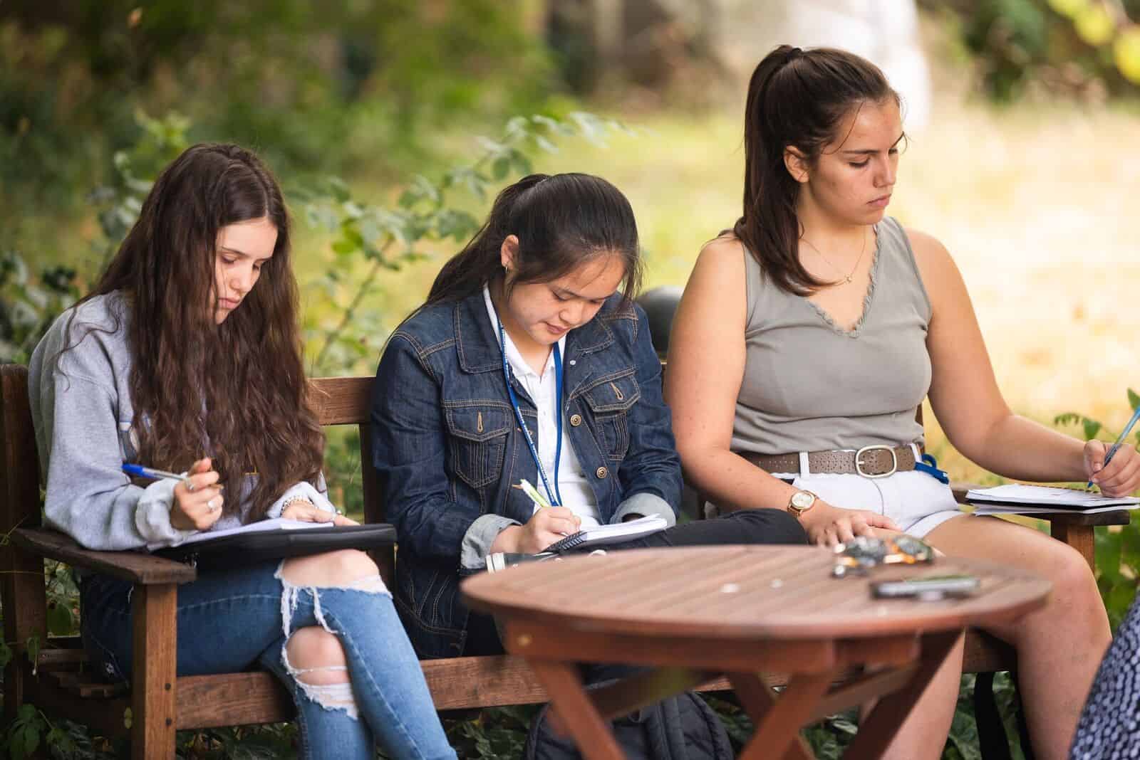 Three students studying hard at our summer school in Oxford