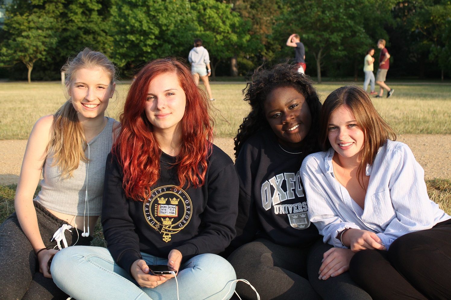 Four summer school students in Oxford University Parks