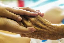 Nurse holding patient's hand