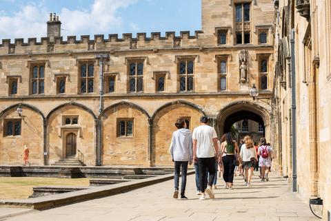 Summer school students touring an Oxford university college