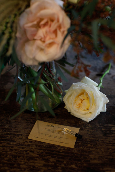 A rose with a Le Labo perfume sample.