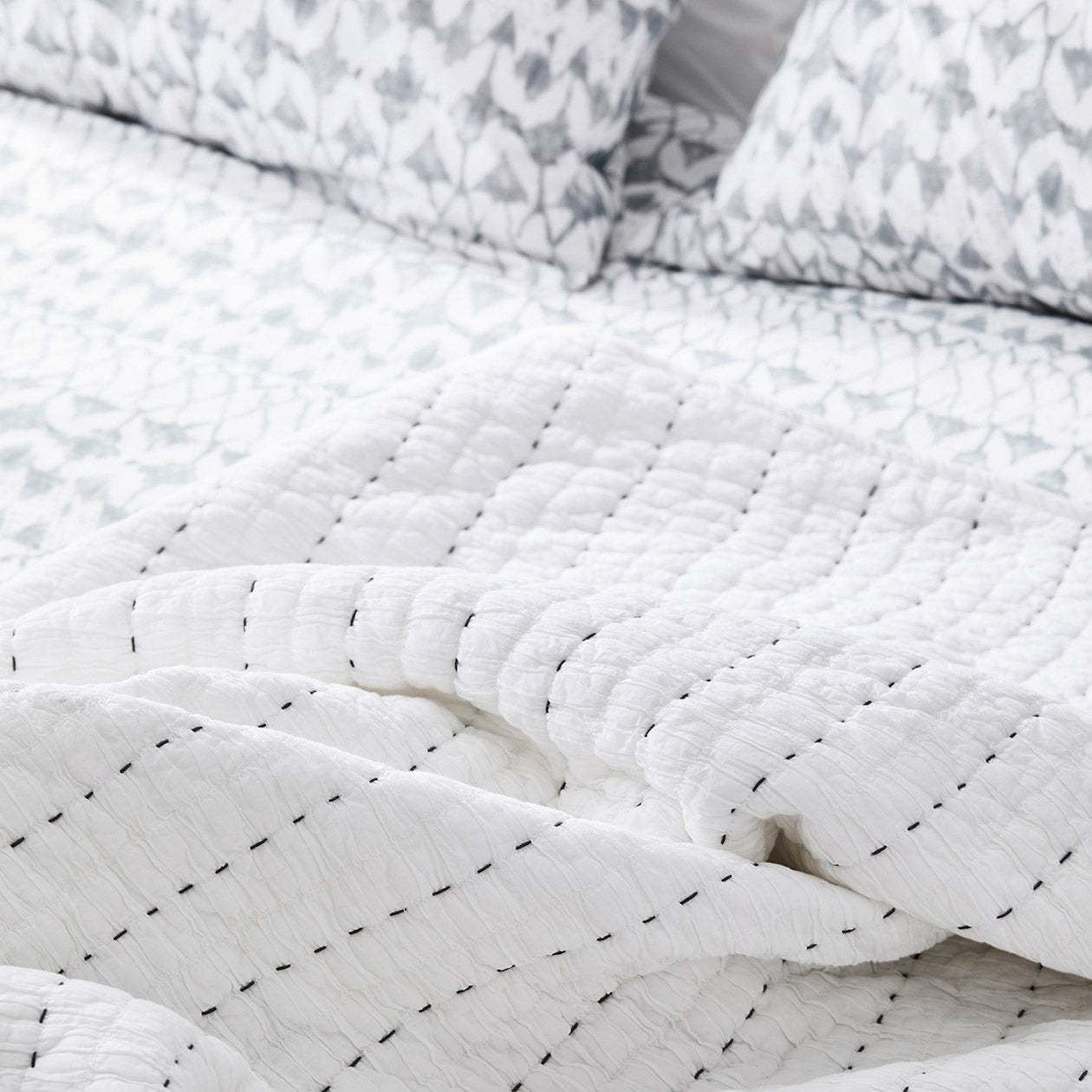white cotton quilt bedspread