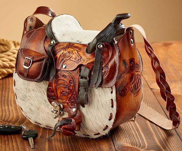 Showman ® Tooled leather saddle bag with hair-on cowhide overlay