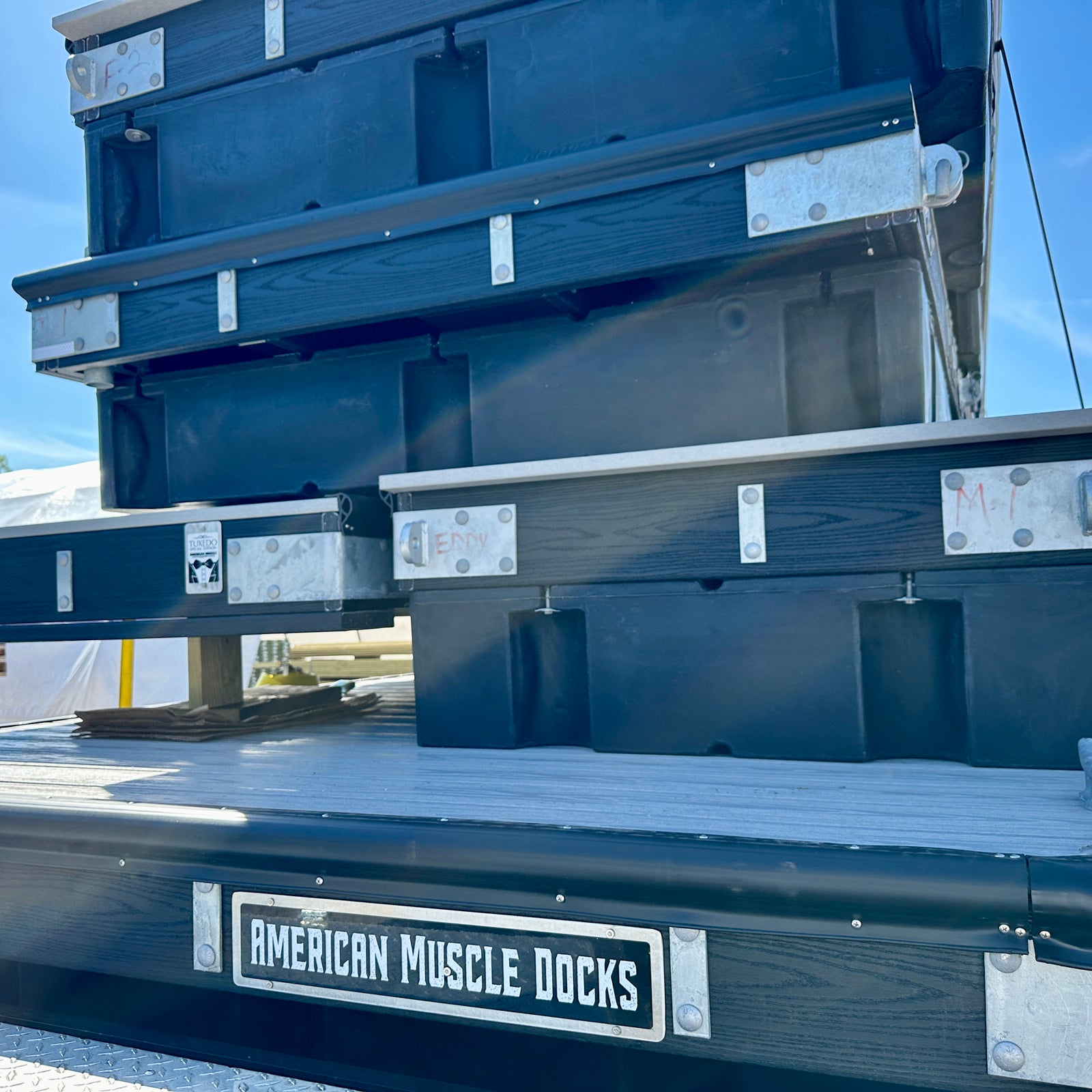 Composite reinforced polymeric boat dock frame