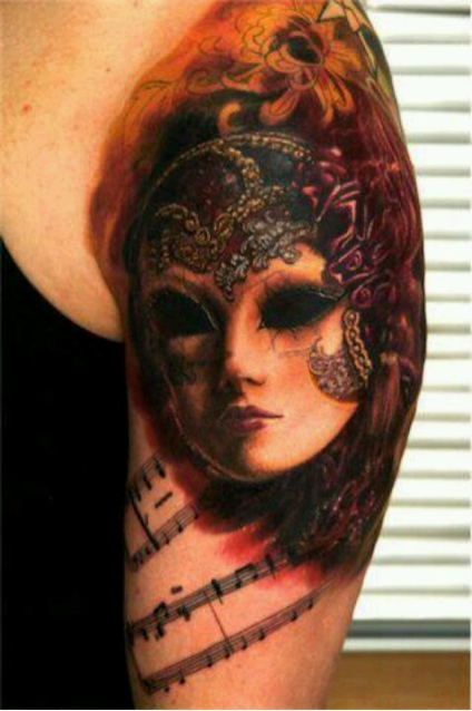 Venetian mask tattoo by Scotty Parker TattooNOW