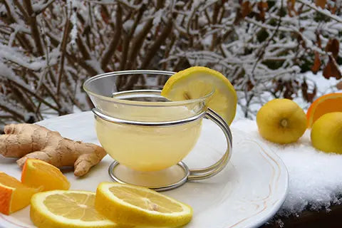 A lemon and ginger tea brewing in a winter scene