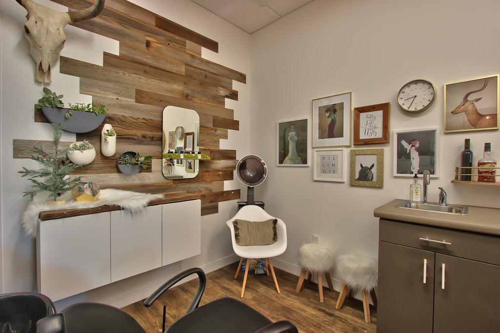 abstract reclaimed timber wall creates focal point for hanging vases on salon wall
