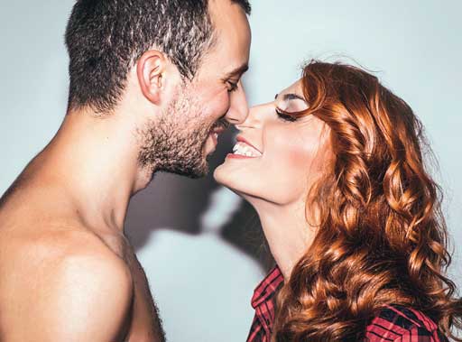 Sexy red head girl kissing trendy guy