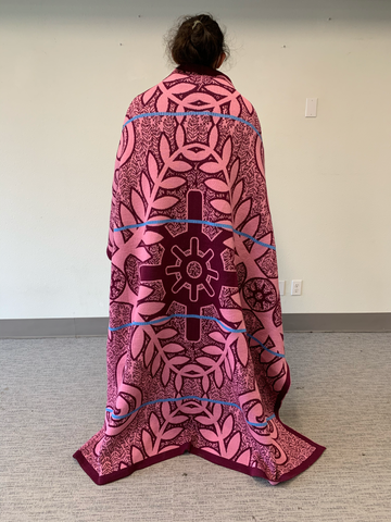 A pink blanket used in Wakanda Forever modeled by an Eighth Generation team member