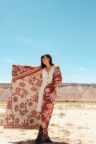 Woman wrapped in red and white wool blanket