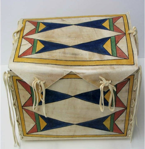 A parfleche box made of rawhide painted with natural pigments in blue, yellow, green, and red