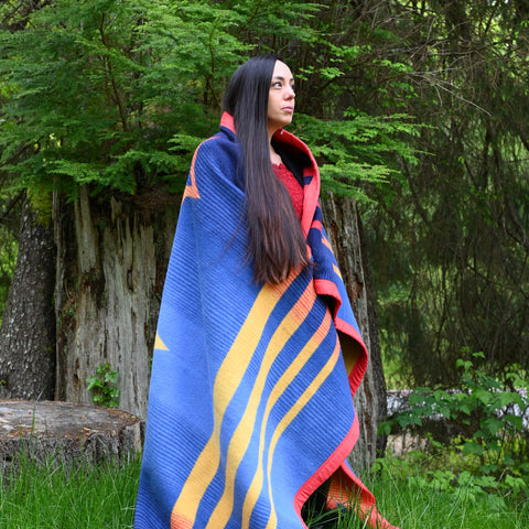 Snoqualmie Tribe Member Bethany Fackrell, US F-18 engine mechanic, models the Warrior Wool Blanket
