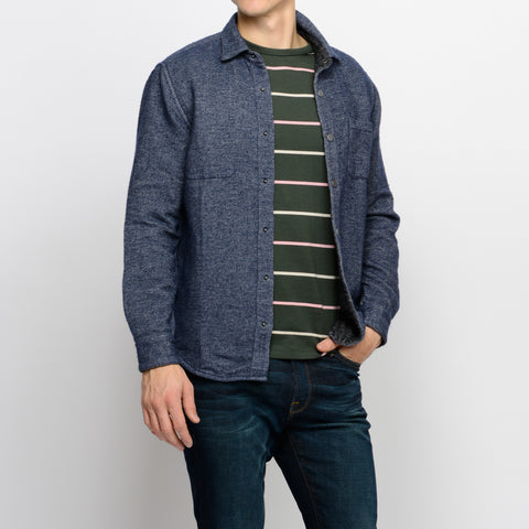 Porguguese flannel shirt layered over green APC shirt