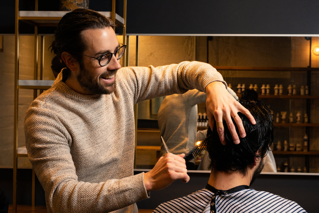 Craig Boa cutting hair at Weekly Trim True