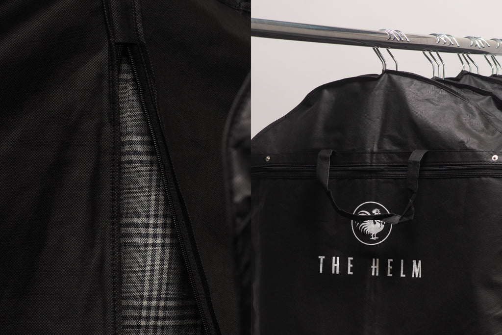 Black Helm garment bags hanging on a rack