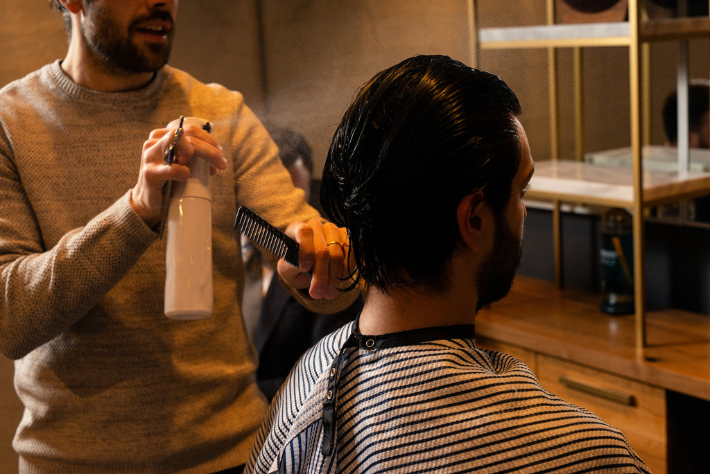 Craig Boa spraying hair with water at Weekly Trim True