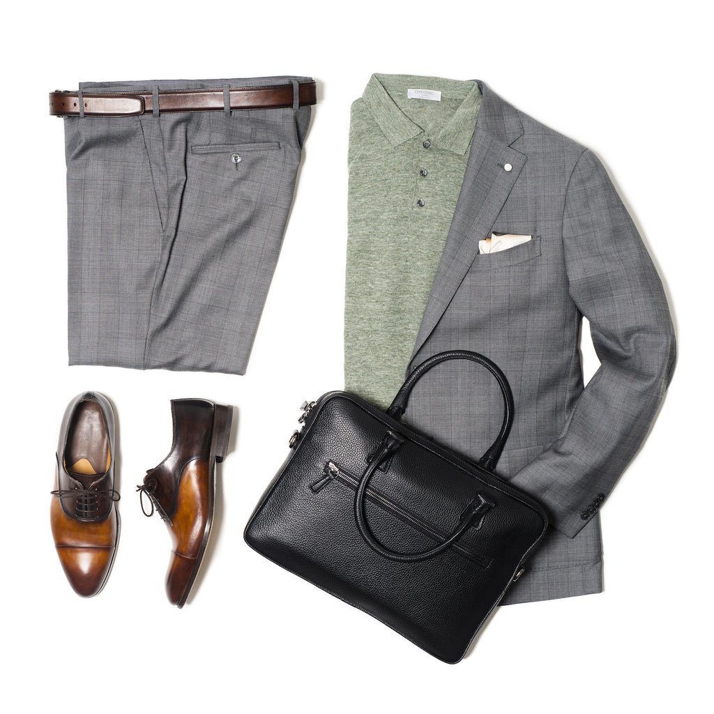 Knit polo with grey check suit and black briefcase