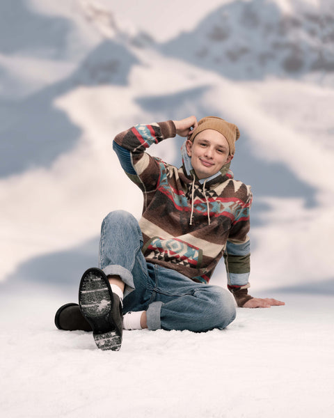 vintage skier in contemporary outfit sitting down