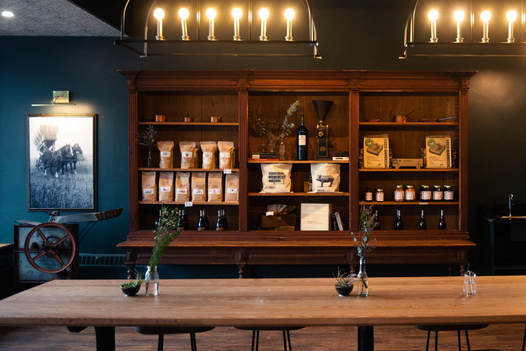 Gifts and preserves inside The Butchery on a wood shelf