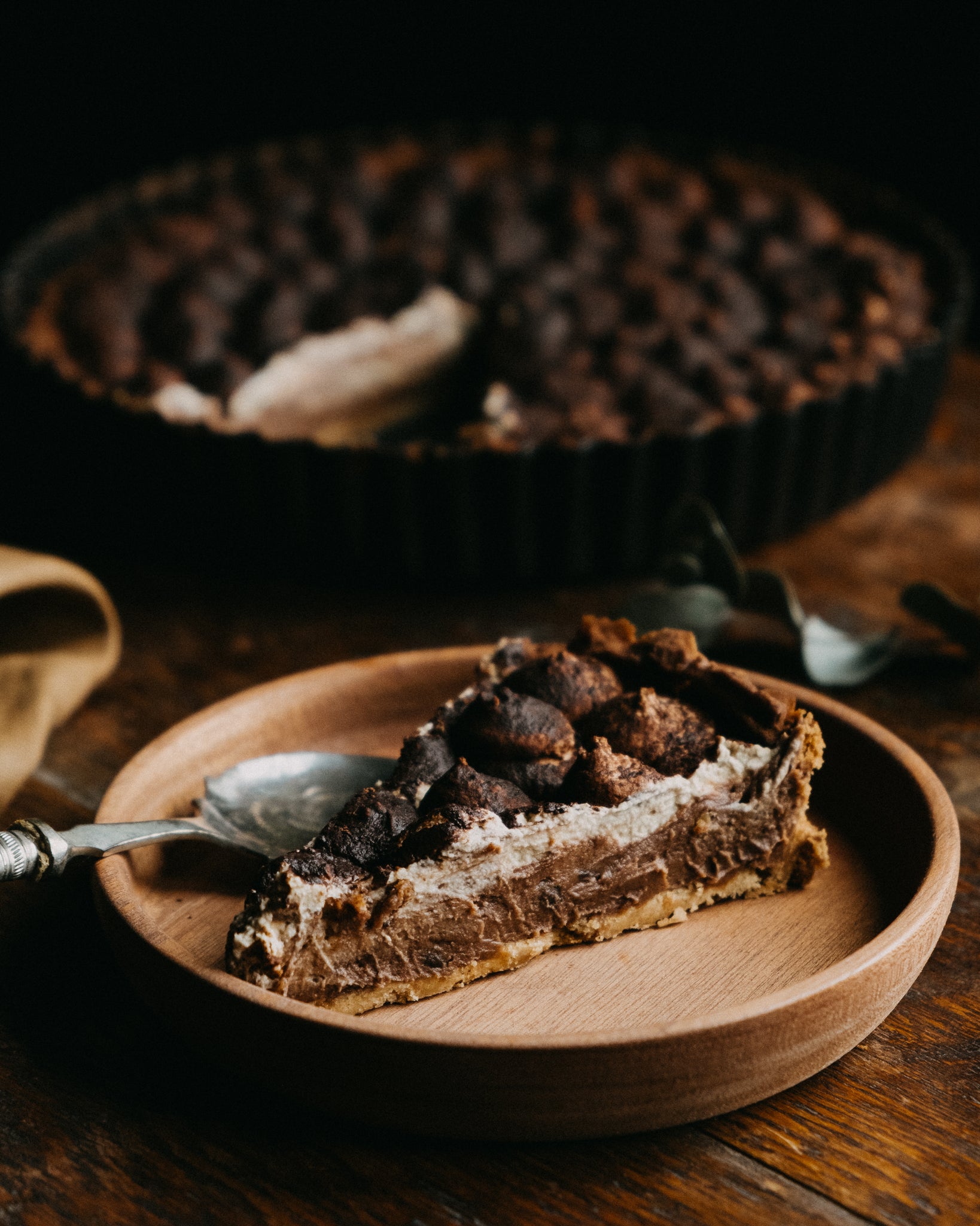 Chocolate tart with mascarpone cream on a linen table cloth