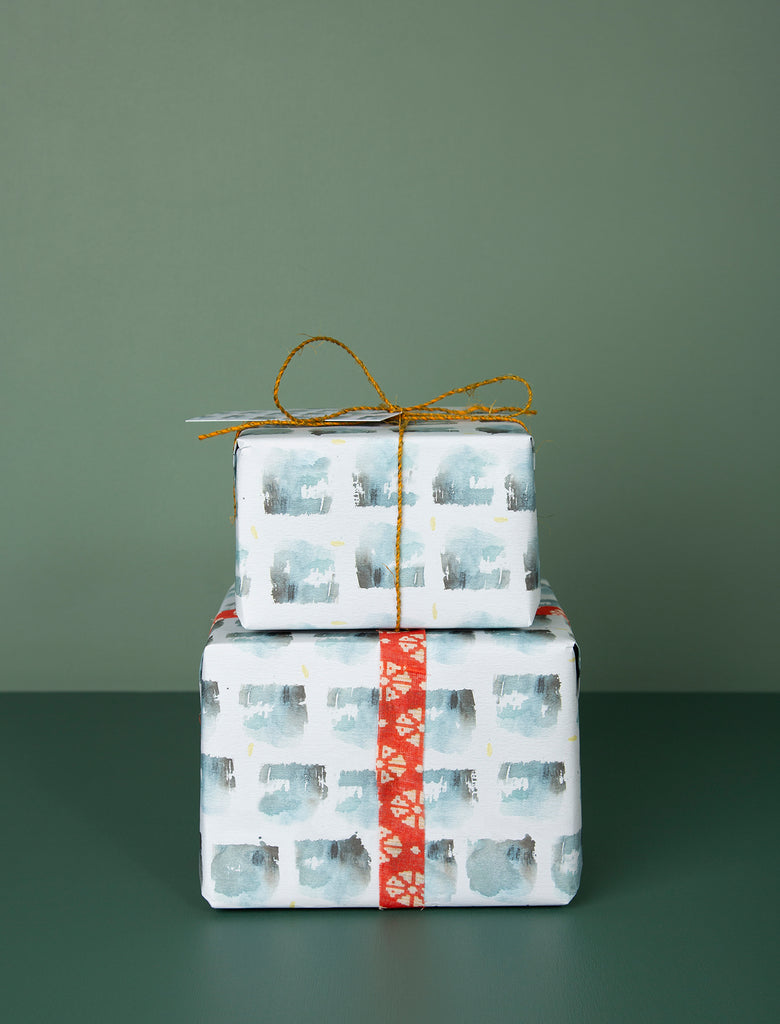 Our gift wrap service includes original design paper from artist Cindy Leong, coloured tissue for delicate items, jute twine and a matching postcard.<format> medium left