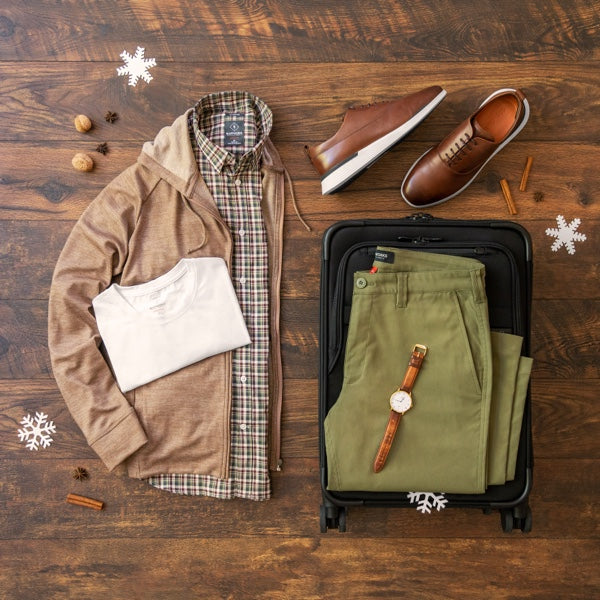 Holiday themed laydown view of Ascender Chinos, Threshold T-Shirt, Meridian Dress Shirt, and Como Hoodie.