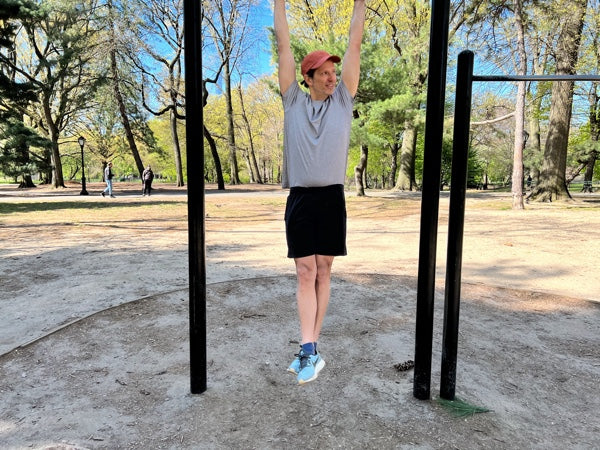 Stefan doing chin ups in Central Park wearing the Rev shorts, Threshold tee and Eardley cap.