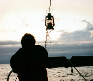 Silhouette of Stefan looking over the ship at the horizon