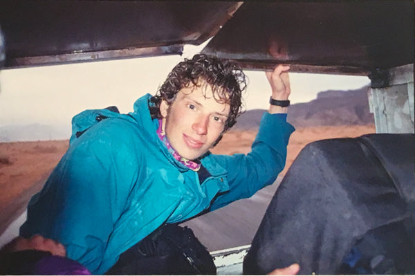 Me hitch-hiking in Jordan as a wide-eyed world traveler in my 20s.