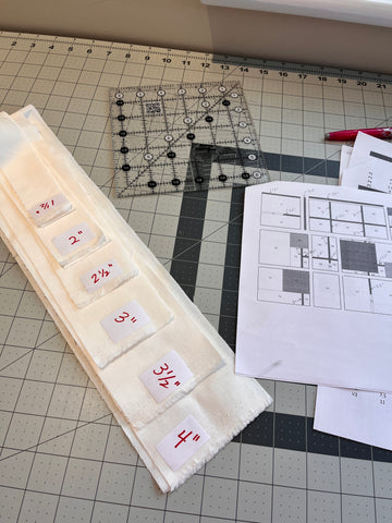 White fabric strips with small adhesive labels with writing on it in red ink.