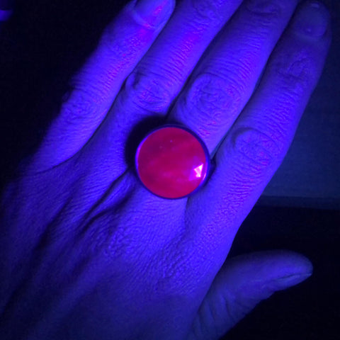 Ruby gemstone ring under UV light 