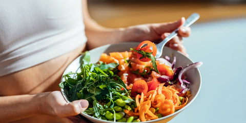 bowl filled with a variety of colorful and nutritious foods, signifying the importance of consuming a healthy diet to support and promote optimal hair growth.